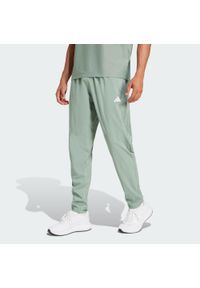 Adidas - Spodnie Own The Run. Kolor: zielony. Materiał: materiał. Sport: bieganie #1