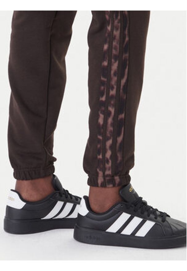 Adidas - adidas Spodnie dresowe Seasonal Essentials Leopard Print KA4720 Brązowy Regular Fit. Kolor: brązowy. Materiał: bawełna. Wzór: nadruk