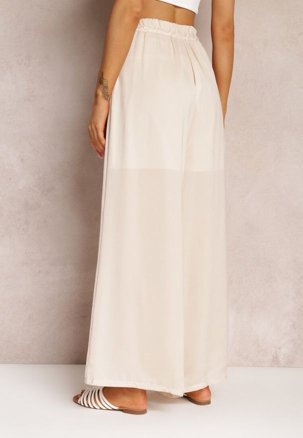 Renee - Jasnobeżowe Spodnie z Szerokimi Nogawkami i Gumką w Pasie Jacobisa. Stan: podwyższony. Kolor: beżowy