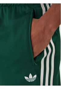Adidas - adidas Spodnie dresowe Firebird KD8317 Zielony Loose Fit. Kolor: zielony. Materiał: syntetyk #3