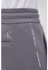 Calvin Klein Jeans Spodnie męskie kolor szary z nadrukiem. Kolor: szary. Materiał: dzianina, włókno. Wzór: nadruk