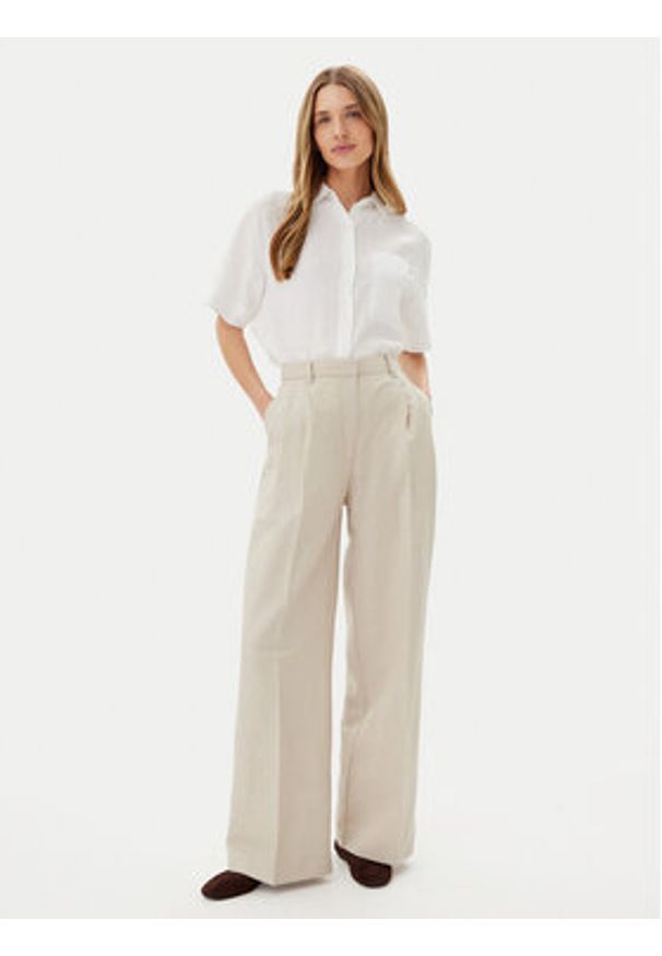 TOMMY HILFIGER - Tommy Hilfiger Spodnie materiałowe WW0WW45460 Beżowy Relaxed Fit. Kolor: beżowy. Materiał: syntetyk