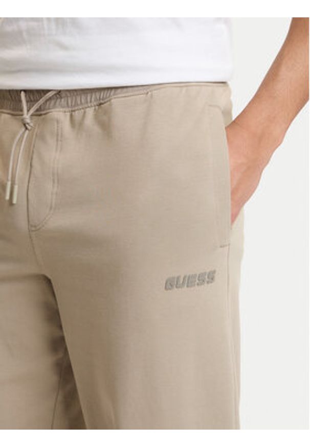 Guess Spodnie dresowe Z6GB01 K2834 Beżowy Regular Fit. Kolor: beżowy. Materiał: bawełna