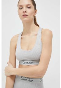 Calvin Klein Performance biustonosz sportowy CK Athletic kolor szary gładki. Kolor: szary. Materiał: materiał. Rodzaj stanika: wyciągane miseczki. Wzór: gładki. Sport: fitness, taniec