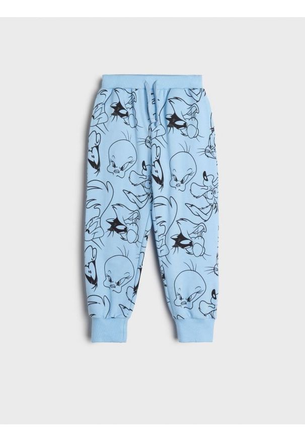 Sinsay - Spodnie dresowe jogger Looney Tunes - niebieski. Kolor: niebieski. Materiał: dresówka. Wzór: nadruk