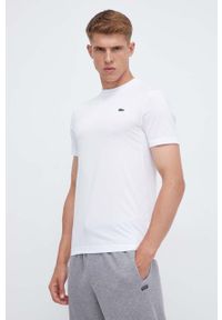 Lacoste t-shirt męski kolor biały gładki. Kolor: biały. Długość rękawa: krótki rękaw. Długość: krótkie. Wzór: gładki. Styl: klasyczny
