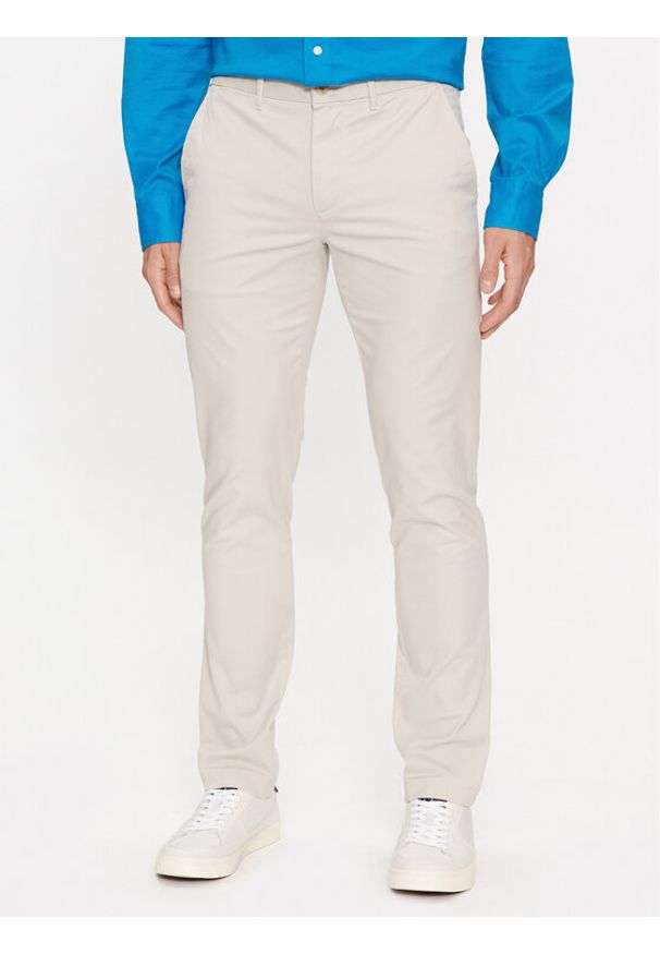 TOMMY HILFIGER - Tommy Hilfiger Chinosy Bleecker MW0MW26619 Beżowy Slim Fit. Kolor: beżowy. Materiał: bawełna