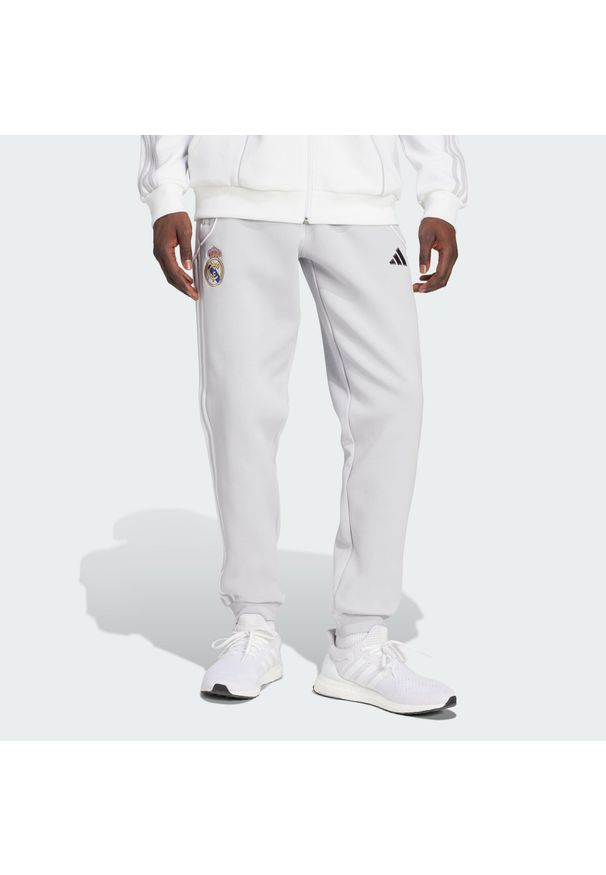 Adidas - Spodnie Real Madrid UBP Doubleknit. Kolor: szary, wielokolorowy, biały. Materiał: dresówka. Sport: piłka nożna