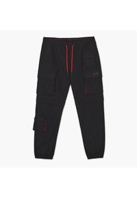 Cropp - Czarne joggery cargo z odpinanymi nogawkami - Czarny. Kolor: czarny. Materiał: tkanina, włókno, dresówka, bawełna. Długość: długie #1