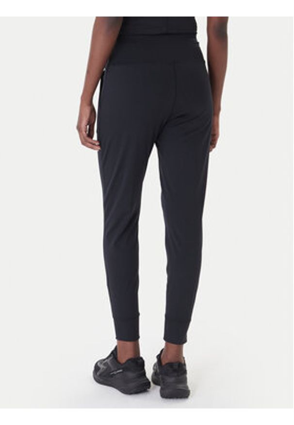 Under Armour Spodnie dresowe Motion 1375077 Czarny Slim Fit. Kolor: czarny. Materiał: syntetyk