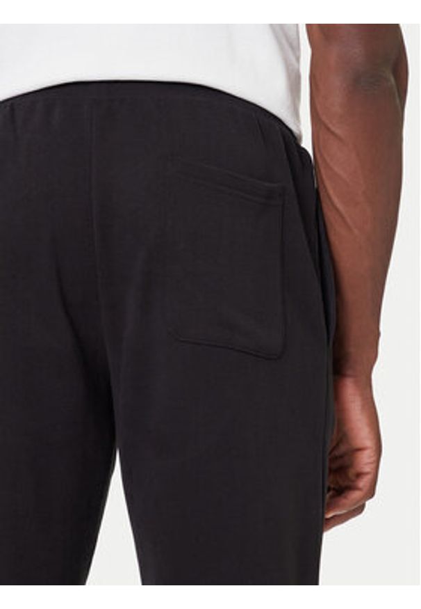 Tommy Jeans Spodnie dresowe DM0DM22094 Czarny Relaxed Fit. Kolor: czarny. Materiał: bawełna