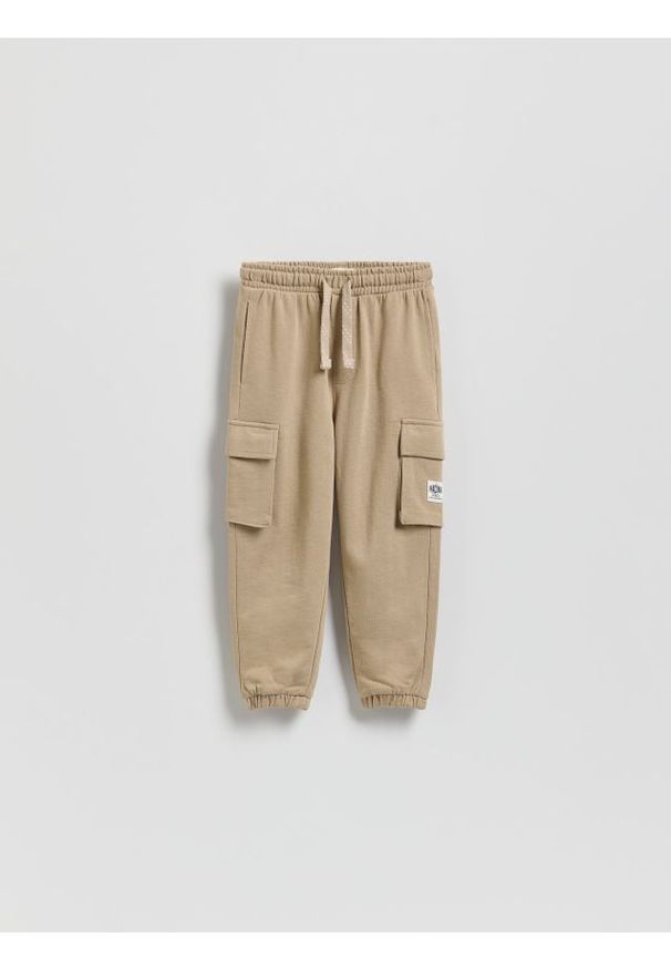 Reserved - Bawełniane joggery cargo - beżowy. Kolor: beżowy. Materiał: bawełna