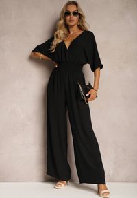 Renee - Czarny Kombinezon o Kopertowym Fasonie z Szerokim Luźnym Dołem i Kieszeniami Octoni. Okazja: na co dzień. Kolor: czarny. Wzór: aplikacja. Styl: elegancki, casual