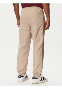 Adidas - adidas Spodnie dresowe Firebird KS7503 Beżowy Regular Fit. Kolor: beżowy. Materiał: syntetyk #2