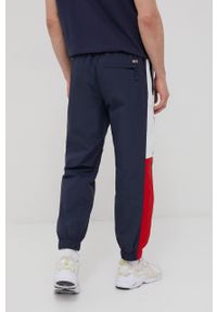 Tommy Jeans spodnie męskie kolor granatowy wzorzyste. Kolor: niebieski. Materiał: poliamid, tkanina