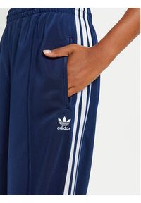 Adidas - adidas Spodnie dresowe Firebird IL3817 Granatowy Loose Fit. Kolor: niebieski. Materiał: syntetyk