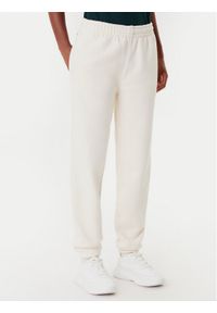 Lacoste Spodnie dresowe XF0353 Beżowy Regular Fit. Kolor: beżowy. Materiał: bawełna #1