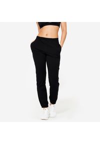 DOMYOS - Spodnie damskie Domyos Gym & Pilates 100 regular. Kolor: czarny. Materiał: bawełna, materiał, elastan. Sport: joga i pilates