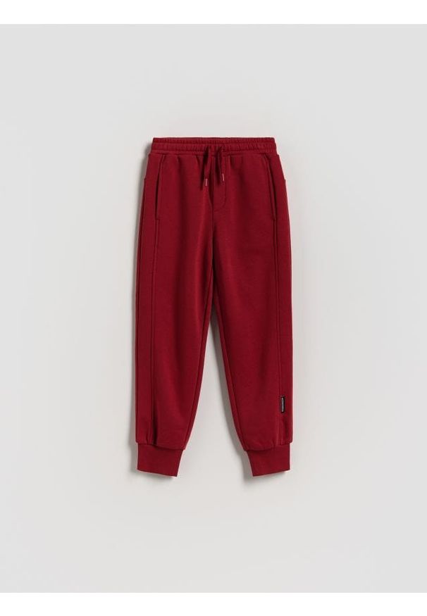 Reserved - Bawełniane joggery z meszkiem - czerwony. Kolor: czerwony. Materiał: bawełna