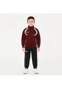 LEGEA - Komplet dresu dla chłopca ALGERIA JUNIOR JR. Okazja: na uczelnię. Kolor: czerwony, wielokolorowy, brązowy, biały. Materiał: dresówka. Styl: sportowy #1