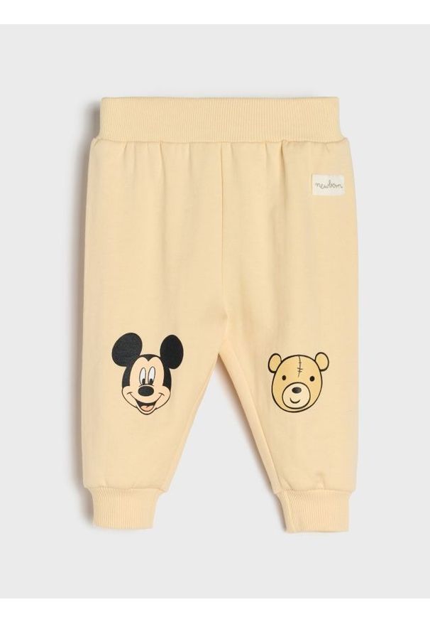 Sinsay - Spodnie z polarem w środku Mickey Mouse - kremowy. Kolor: kremowy. Materiał: polar. Wzór: motyw z bajki