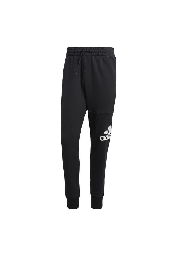Adidas - Spodnie dresowe adidas Essentials French Terry Tapered Cuff. Kolor: czarny. Materiał: dresówka