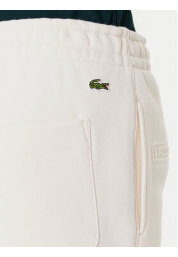 Lacoste Spodnie dresowe XF0353 Beżowy Regular Fit. Kolor: beżowy. Materiał: bawełna