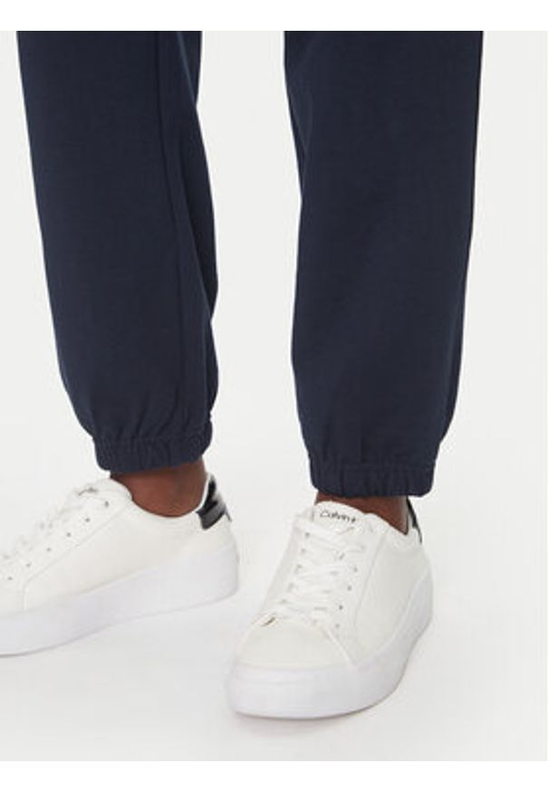 Calvin Klein Jeans Spodnie dresowe Monologo LV047B235G Granatowy Regular Fit. Kolor: niebieski. Materiał: bawełna