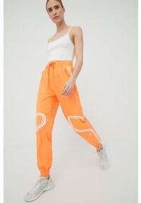 Adidas by Stella McCartney - adidas by Stella McCartney spodnie treningowe Truepace HC2985 damskie kolor pomarańczowy z nadrukiem. Kolor: pomarańczowy. Materiał: materiał. Wzór: nadruk #5