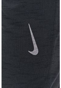 Nike Spodnie męskie kolor szary gładkie. Kolor: szary. Wzór: gładki