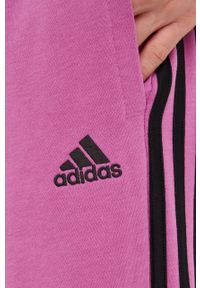 Adidas - adidas spodnie dresowe damskie kolor fioletowy z aplikacją. Kolor: fioletowy. Materiał: dresówka. Wzór: aplikacja #4