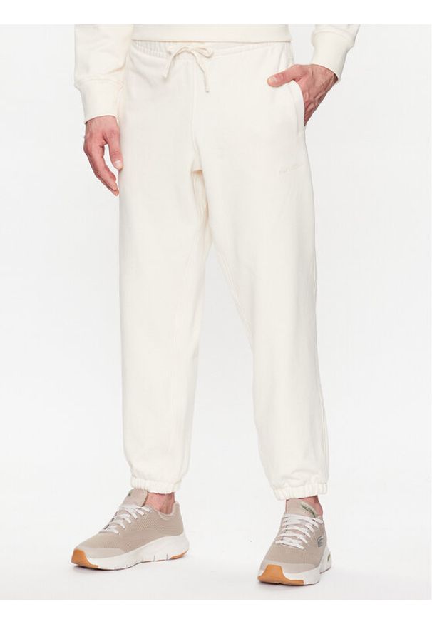 New Balance Spodnie dresowe MP23551 Écru Relaxed Fit. Materiał: bawełna