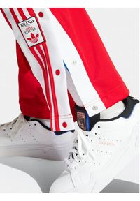 Adidas - adidas Spodnie dresowe Adibreak IP0620 Czerwony Regular Fit. Kolor: czerwony. Materiał: syntetyk