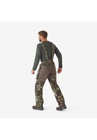 SOLOGNAC - Spodnie z szelkami Solognac 900 Warm wodoodporne camo treemetic. Kolor: zielony, brązowy, wielokolorowy. Materiał: tkanina, skóra. Sport: outdoor