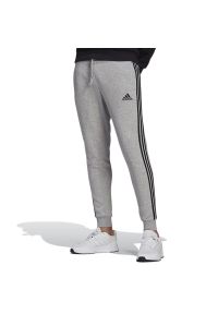 Adidas - Spodnie adidas Essentials Slim 3-Stripes GM1091 - szare. Kolor: szary. Materiał: bawełna, dresówka, poliester, wiskoza #1
