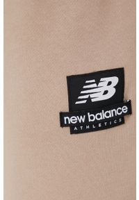 New Balance spodnie dresowe bawełniane MP21550MDY męskie kolor beżowy z nadrukiem. Kolor: beżowy. Materiał: bawełna, dresówka. Wzór: nadruk #3