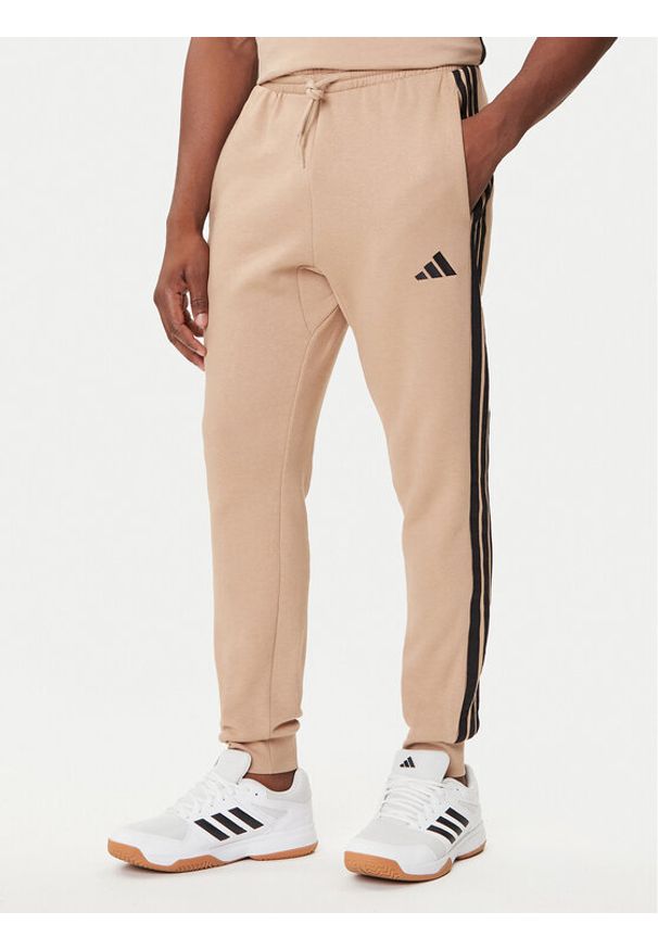 Adidas - adidas Spodnie dresowe Essentials 3-Stripes JX0712 Beżowy Regular Fit. Kolor: beżowy. Materiał: bawełna