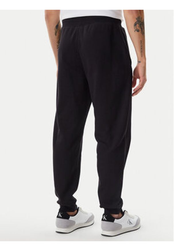Calvin Klein Jeans Spodnie dresowe LV040BM802 Czarny Regular Fit. Kolor: czarny. Materiał: bawełna