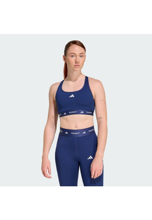 Adidas - Biustonosz TECHFIT. Kolor: niebieski. Materiał: materiał. Technologia: Techfit (Adidas). Sport: fitness
