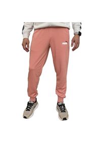Puma - Spodnie Do Joggingu Męskie Logo ESS+. Kolor: pomarańczowy, wielokolorowy, żółty. Materiał: dresówka. Sport: bieganie
