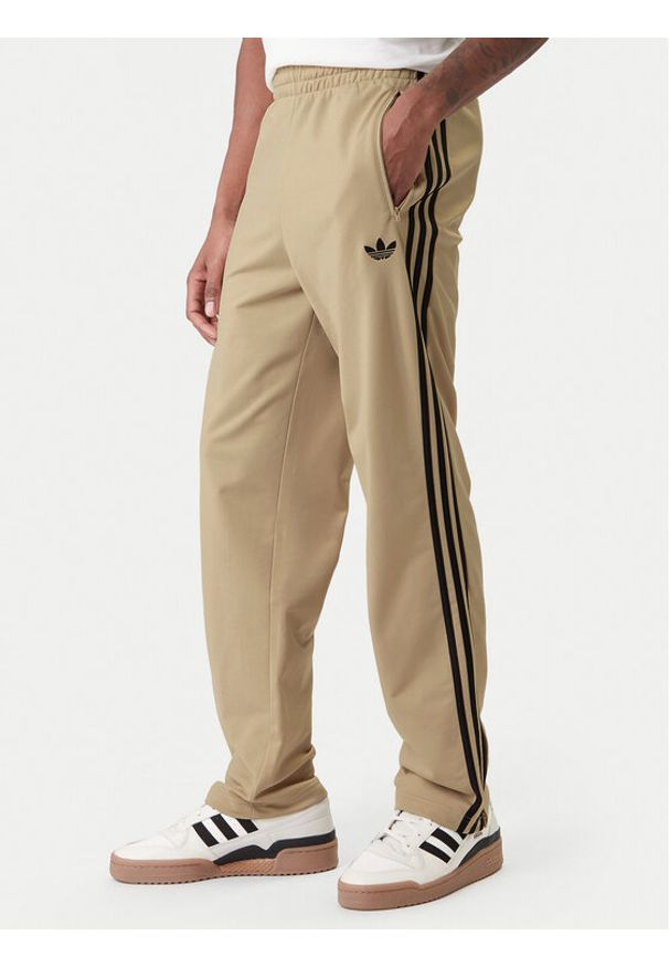 Adidas - adidas Spodnie dresowe Firebird KE6679 Beżowy Loose Fit. Kolor: beżowy. Materiał: syntetyk