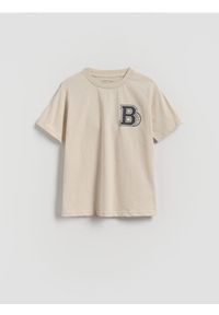 Reserved - Bawełniany t-shirt z nadrukiem - kremowy. Kolor: kremowy. Materiał: bawełna. Wzór: nadruk