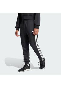 Adidas - Spodnie Essential 3-Stripes French Terry. Kolor: biały, wielokolorowy, czarny. Materiał: materiał