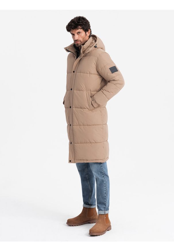 Ombre Clothing - Pikowana długa kurtka męska z odpinanym kapturem – beżowa V2. Typ kołnierza: kaptur. Kolor: beżowy. Materiał: guma, puch, tkanina, poliester, materiał, syntetyk. Długość: długie. Wzór: gładki, aplikacja, ze splotem