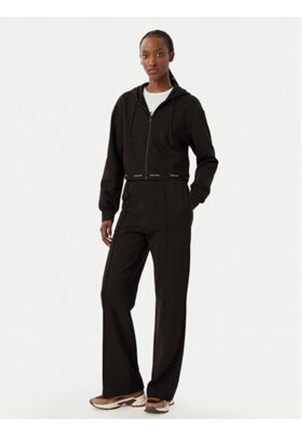 Calvin Klein Jeans Spodnie dresowe LV047G253G Brązowy ciemny Relaxed Fit. Kolor: brązowy. Materiał: bawełna