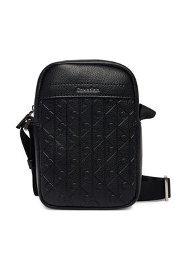 Calvin Klein Saszetka Emblem Aop Emboss Slim Reporter LV04D3228G Czarny. Kolor: czarny. Materiał: skóra