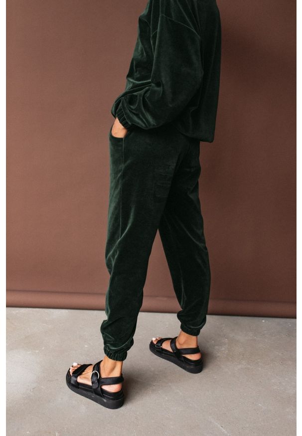 Marsala - Spodnie typu jogger wykonane z weluru w kolorze CIEMNOZIELONYM - DISPLAY VELVET BY MARSALA. Stan: podwyższony. Kolor: zielony. Materiał: welur. Styl: klasyczny, elegancki