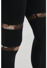 Reebok legginsy damskie kolor czarny z aplikacją. Stan: podwyższony. Kolor: czarny. Materiał: poliester, materiał. Wzór: aplikacja