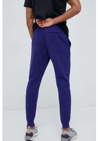 Under Armour spodnie dresowe kolor fioletowy gładkie 1357128-012. Kolor: fioletowy. Materiał: dresówka. Wzór: gładki #3