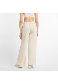 Spodnie damskie New Balance WP51503LIN – beżowe. Kolor: beżowy. Materiał: bawełna, poliester. Wzór: haft, aplikacja #5